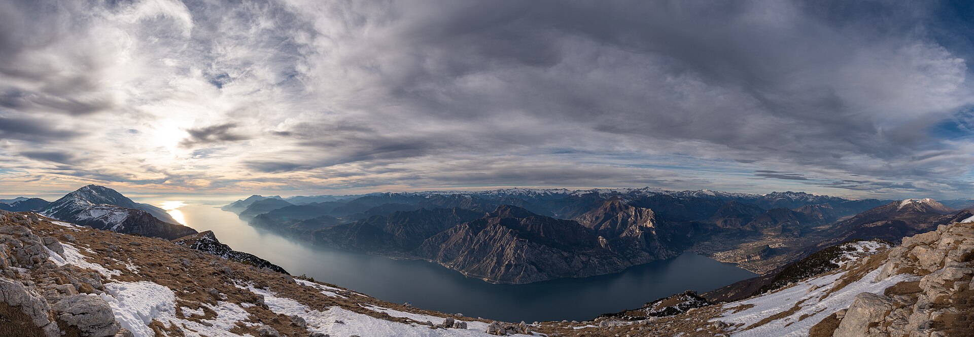 Panorama from Brentonico: Lake Garda , Monte Baldo - higher summits in left side - a view to Limone sul Garda and mountains at the steep lake shore, R